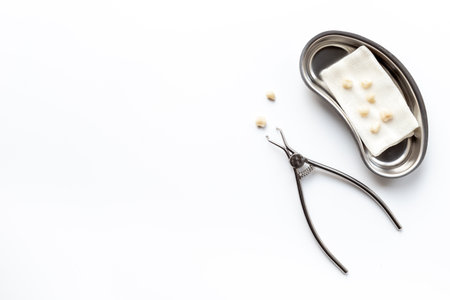 Many dental metal tools and teeth crowns in tray for dental implantation on white background. Professional Dentist tools, top view.の写真素材