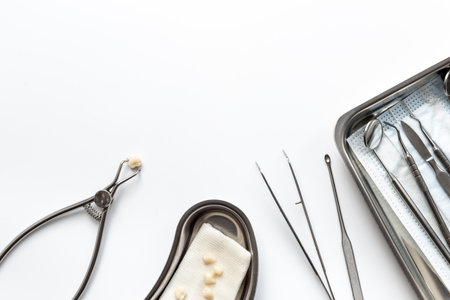 Many dental metal tools and teeth crowns in tray for dental implantation on white background. Professional Dentist tools, top view.の写真素材