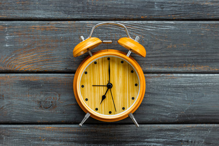 Vintage alarm clock with bells at seven o'clock. Morning routine. In time concept.の写真素材