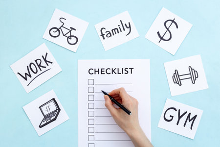 Hand writes in Checklist and many paper cards with hand drawing of different life activities, top view. Life balance and planning conceptの写真素材