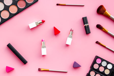 Pattern of various makeup tools and cosmetics products. Blusher, mascara, lipstick, nail polish and brushes, top view.の写真素材