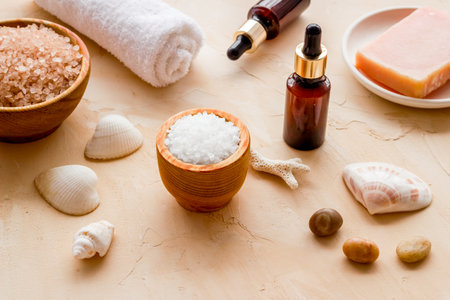 Spa treatment body care cosmetics close up. Sea salt in bowl and essential oil on bottleの写真素材