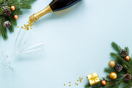 Christmas bottle of champagne with two glasses and fir tree branches, top view. Happy New Year and Merry Christmas decoration.の写真素材