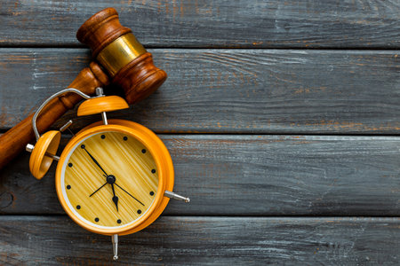 Alarm clock judges gavel, top view. Deadline and time management concept.の写真素材