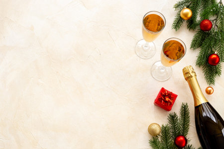 Christmas bottle of champagne with two glasses and fir tree branches, top view. Happy New Year and Merry Christmas decoration.の写真素材