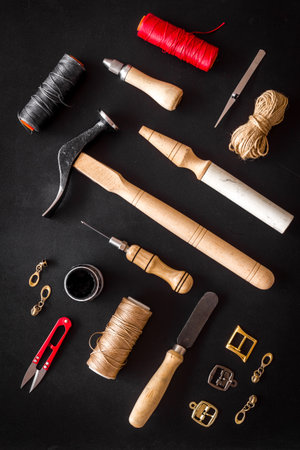 Tools for repair shoes. Hammer, awl, knife, thread on table, top viewの写真素材