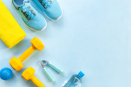 Sports equipment flat lay. Sneakers and dumbbells for fitnessの写真素材