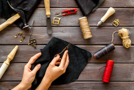 Leather craftsman or shoemaker on workplace with tools, top viewの写真素材