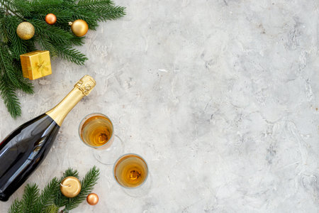 Christmas fir tree branch with champagne bottle and decoration, top view. Happy New Year greeting cardの写真素材