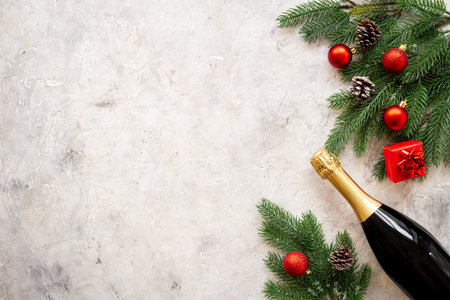 Christmas fir tree branch with champagne bottle and decoration, top view. Happy New Year greeting cardの写真素材