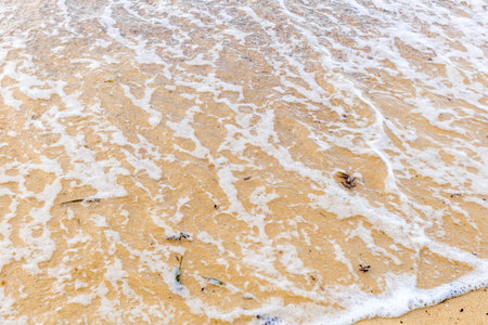 Sand beach with sea waves at coast. Copy spaceの写真素材