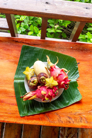 Set of tropical fruit on wooden table , top view. Pitaya fruit, lychee, mangosteen, mangoの写真素材
