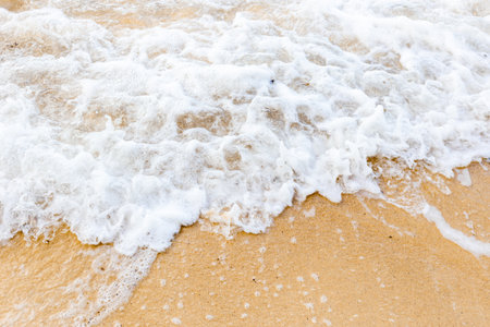 Sand beach with sea waves at coast. Copy spaceの写真素材