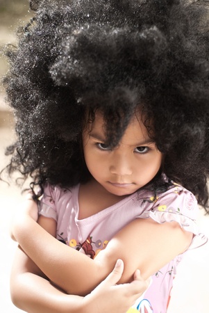 Portrait of a cute little girl in angry actionの写真素材