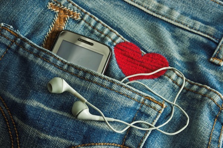 Mp3 player and  Mobile Phone  in a jeans pocketの写真素材
