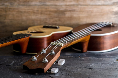 ukulele against a wooden background.