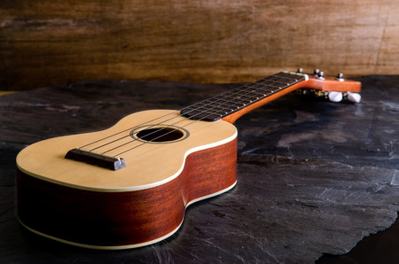 ukulele against a stone  background.の写真素材