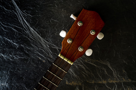 ukulele against a stone  background.の写真素材