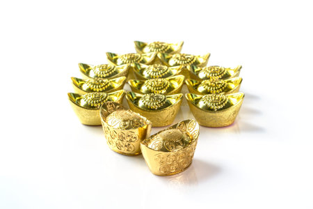 Stack of Chinese Gold Ingots on White Backgroundの写真素材