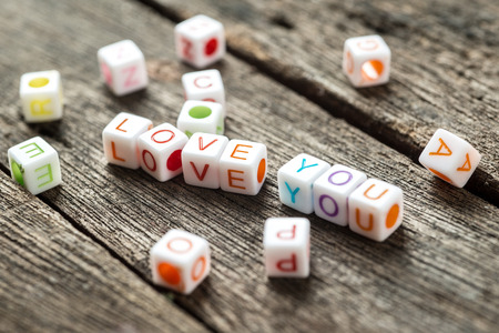Love message written in  blocks. Wooden Background,Selective focusの写真素材