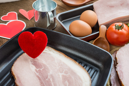 Heart in a frying pan for Love or Heart Healthy Cooking Conceptの写真素材