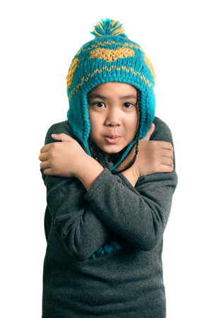 portrait of adorable happy child cold girl in warm hat , isolated on whiteの写真素材