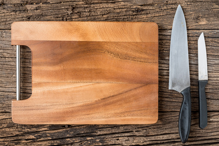 The brown wooden Cutting board  on a rustic table closeup. horizontal top view, wooden background.の写真素材
