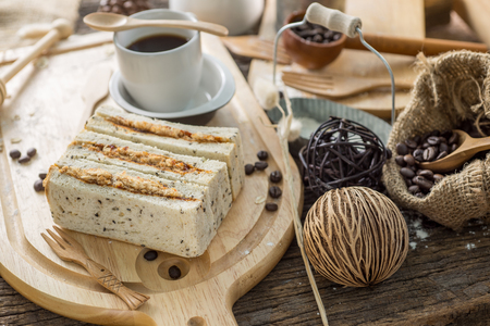 Close up of coffee cup and freshly baked bread with flour on a wooden table topの写真素材