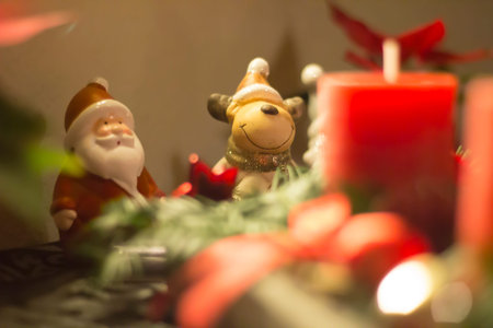 Santa Claus with Reentier on the table behind candleの写真素材