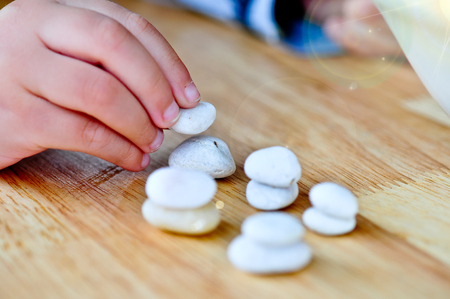 hand building Stone tower on wooden table, education concept.の写真素材