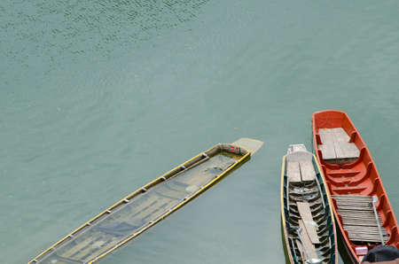 Rowing boat leaks immersed in water.の写真素材