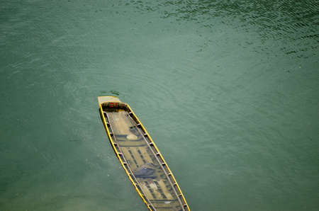 Rowing boat leaks immersed in water.の写真素材