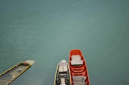 Rowing boat leaks immersed in water.の写真素材