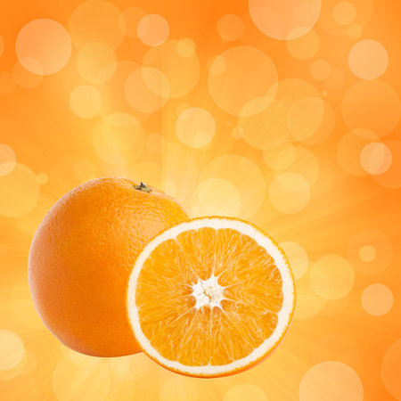 One and half oranges on abstract bokeh background 