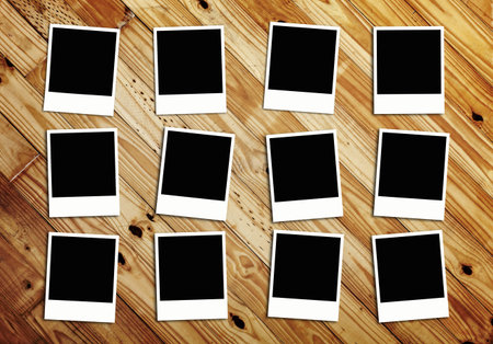 Twelve Blank Photos on wood backgroundの写真素材