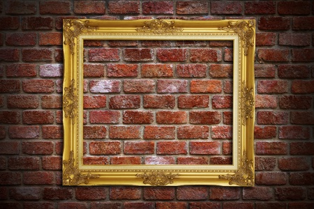 Gold frame on old brick wall backgroundの写真素材