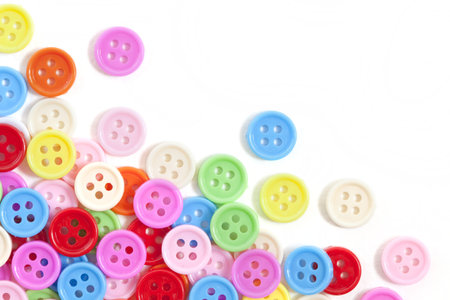 Multi color buttons on white background with copy space