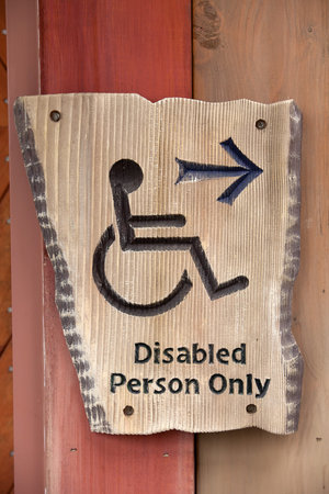 A handicapped sign on wood wall の写真素材