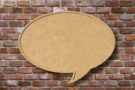 Recycle paper speech bubble on old brick wall background