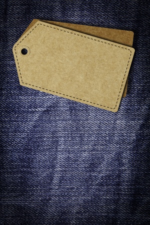 Recycle Paper Label on old blue jean textureの写真素材