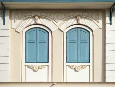 Blue painted wood arched windows in classic wallの写真素材
