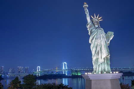 Statue of Liberty and Rainbow bridge at Odaiba Tokyo in twilightの写真素材