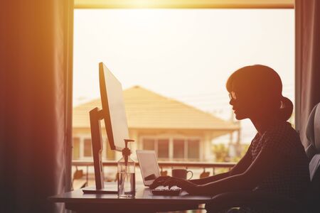 WFH Work From Home Concept,Young Women is working from home during Coronavirus or Covid-19 quarantine, coronavirus covid 19 infected patient in coronavirus covid 19 quarantine room using computerの写真素材