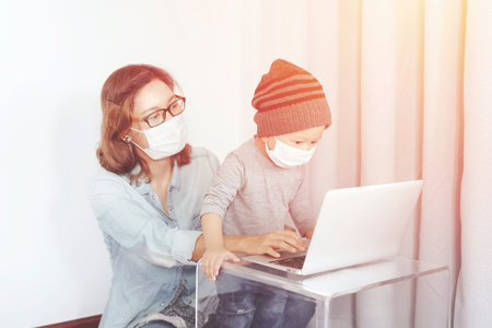 Work from home concept, Young mother in home office with computer and her son