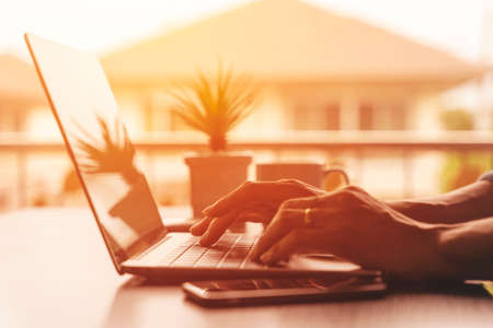 Close up of male hands typing on modern laptop computerの写真素材