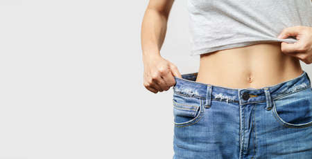 skinny woman body with Loose pants jeans, Light weight body with loose clothesの写真素材