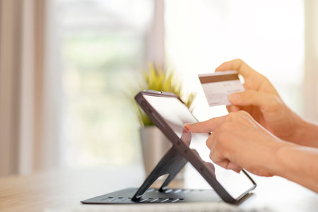 Online shopping concept,Hand holding a credit card and using tablet pc