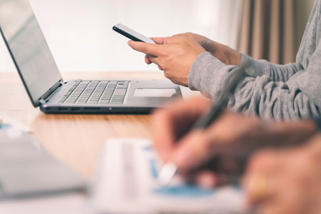 Office worker using his mobile phone in the office. Business concept