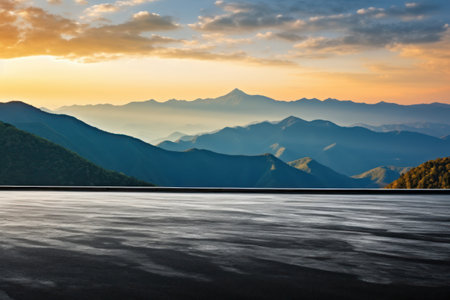 Mountain lake at sunset with asphalt parking.