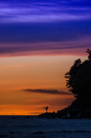 Utthita Hasta Padangusthasana B  Extended Hand Big Toe Posture  - Yoga Pose on the rock during beautiful sunsetの写真素材